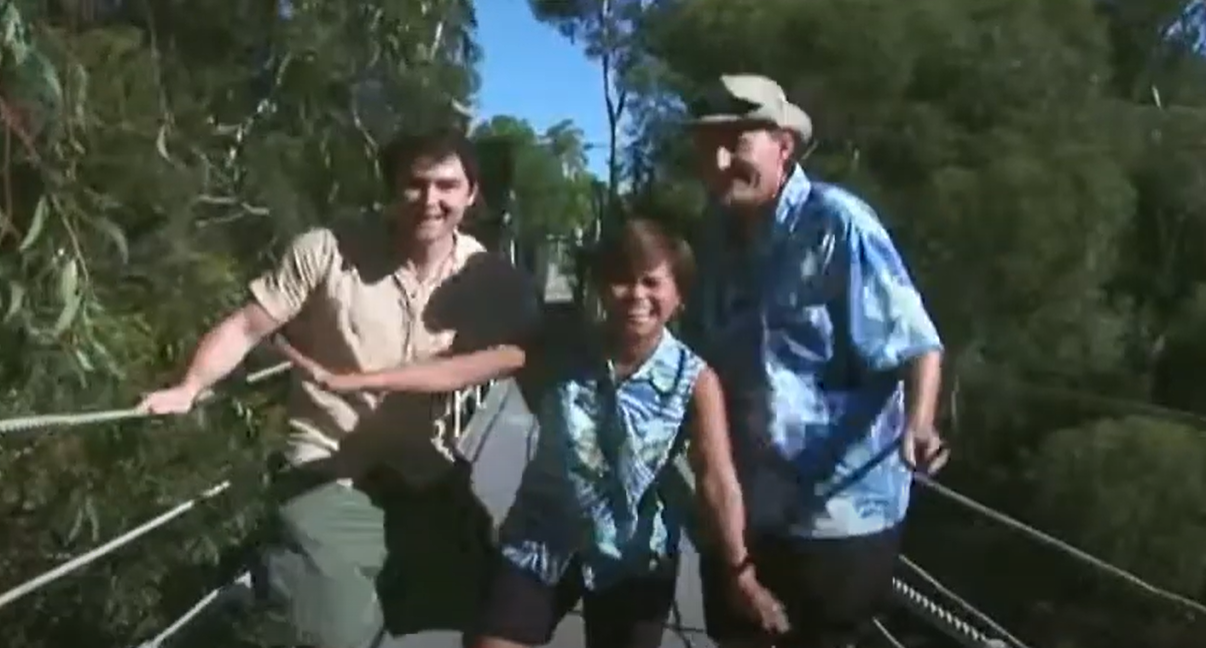 3 people on a walking bridge
